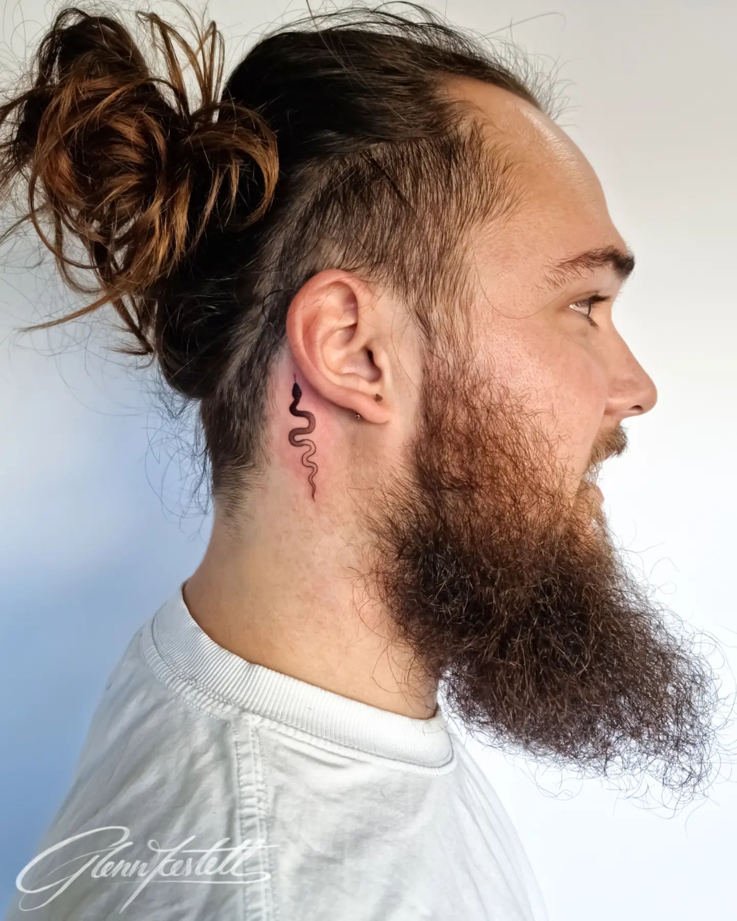 Tatuaje de serpiente detrás de la oreja