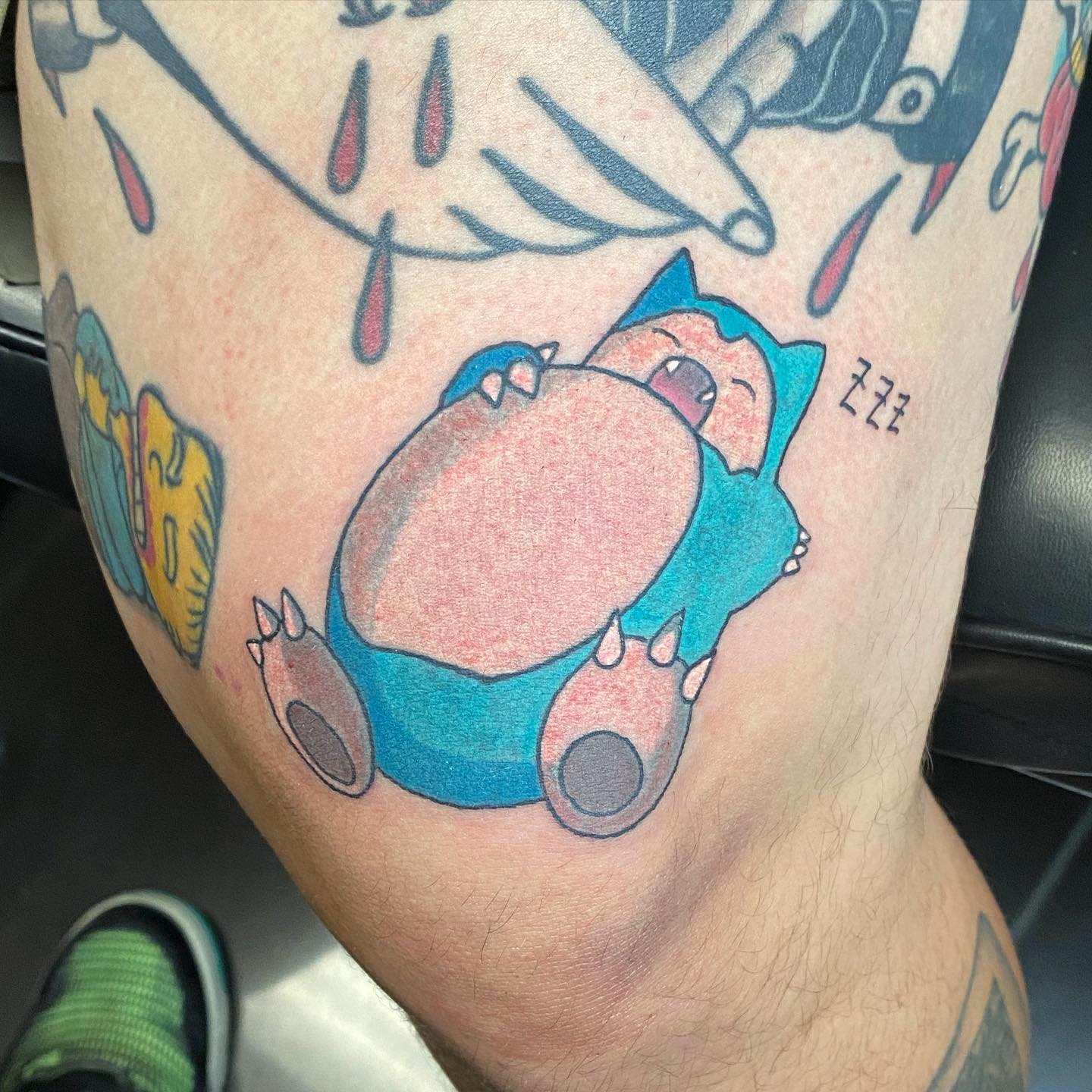 Tatuaje de Pokemon sobre la rodilla.