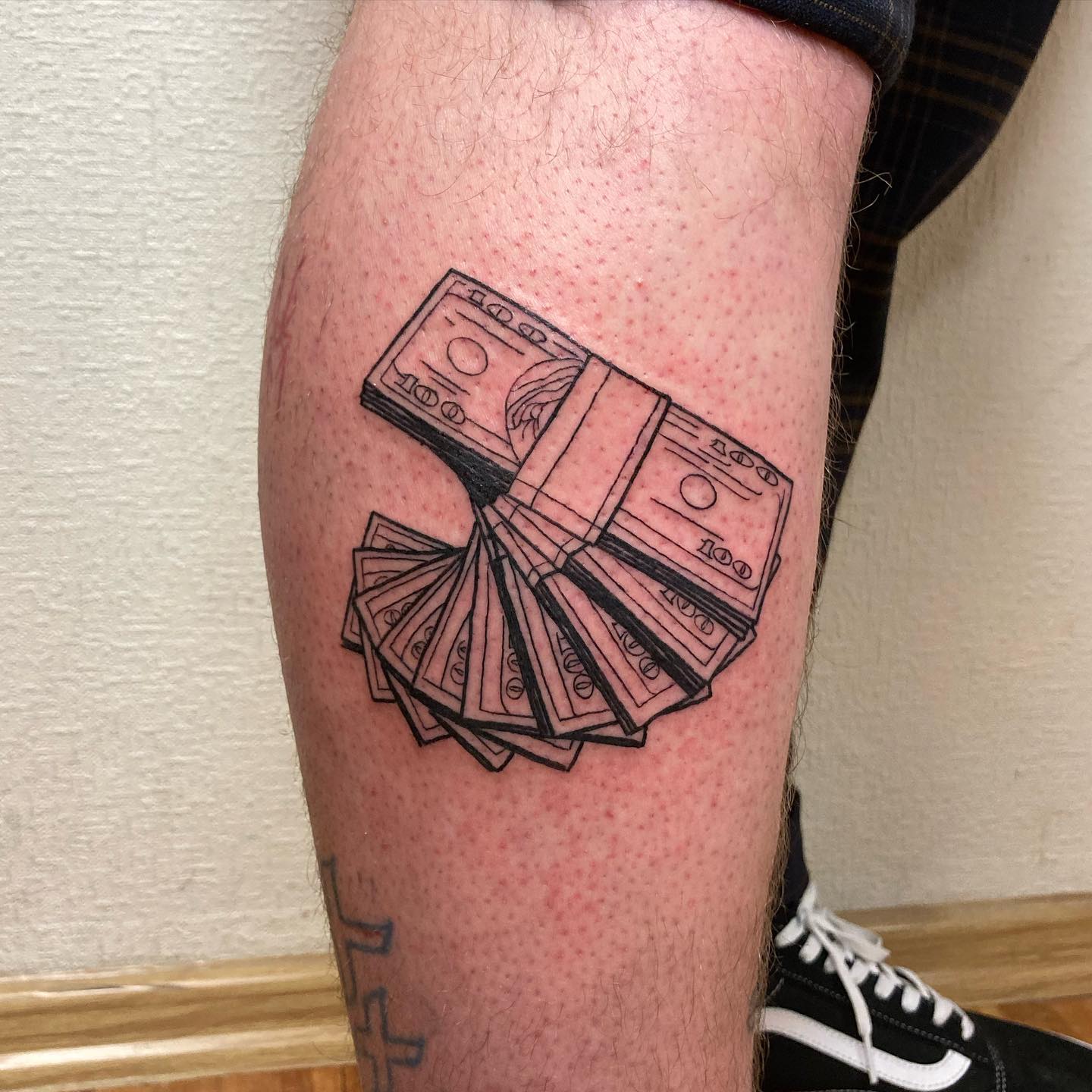 Tatuaje de dinero en la pantorrilla