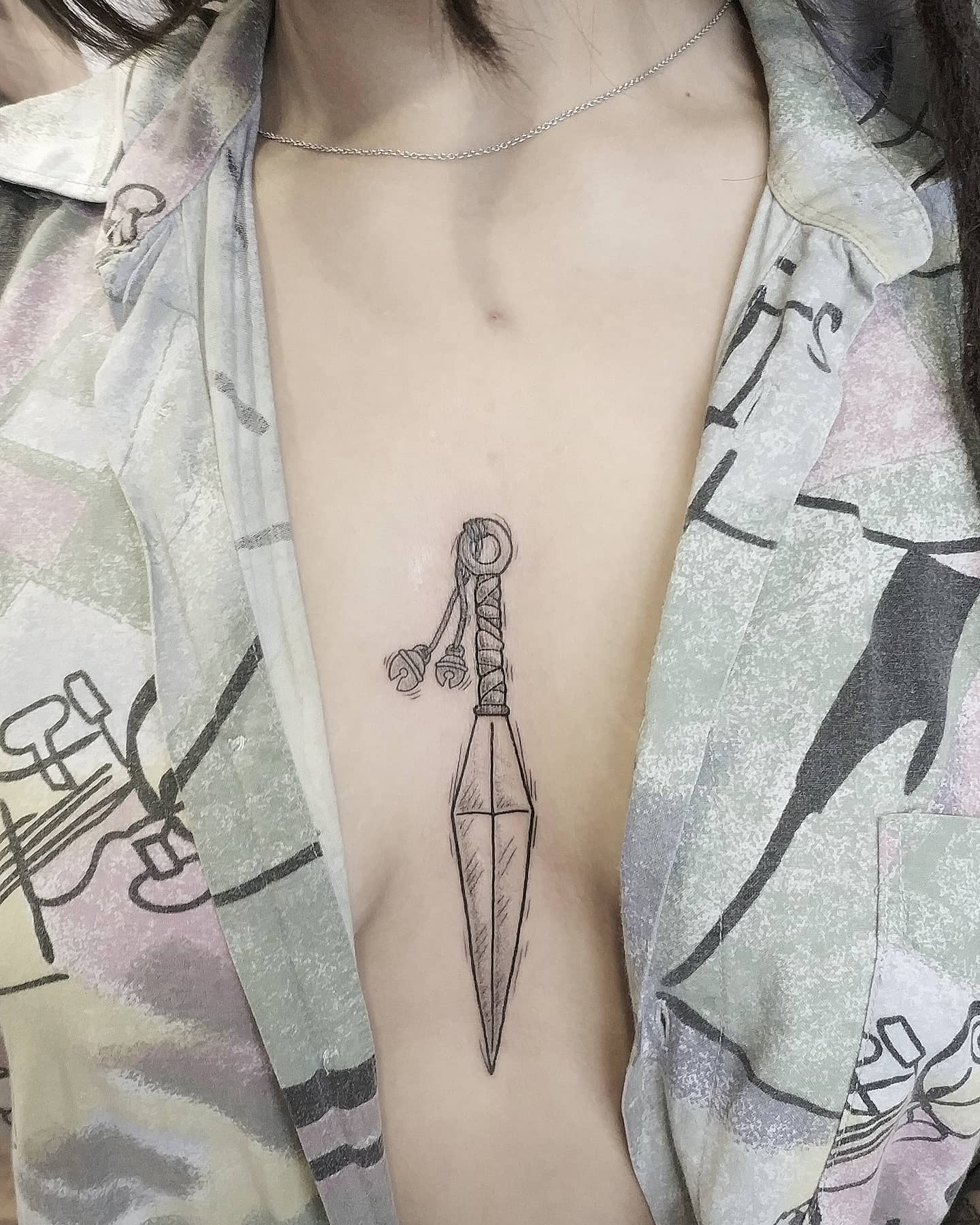 Tatuaje de Daga Entre los pechos
