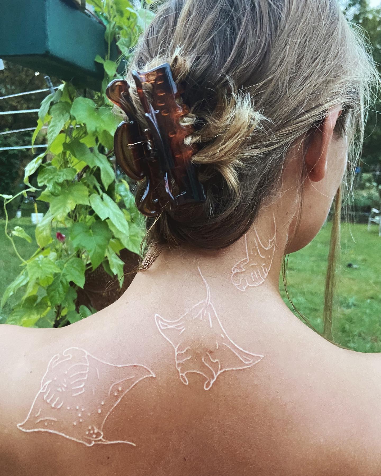 Tatuaje de raya puntas blancas con tinta blanca