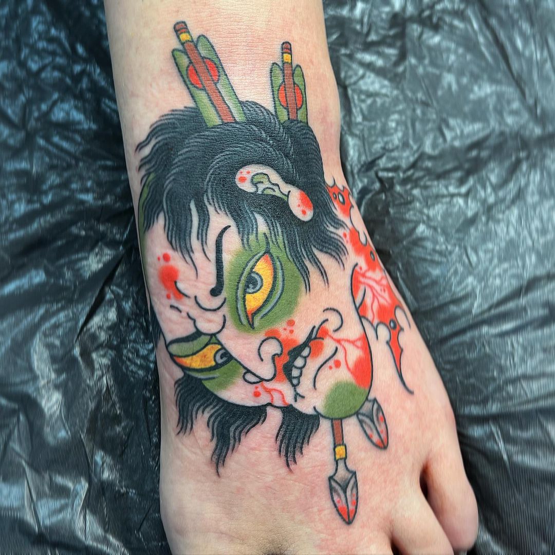 Tatuaje de Namakubi en el pie.
