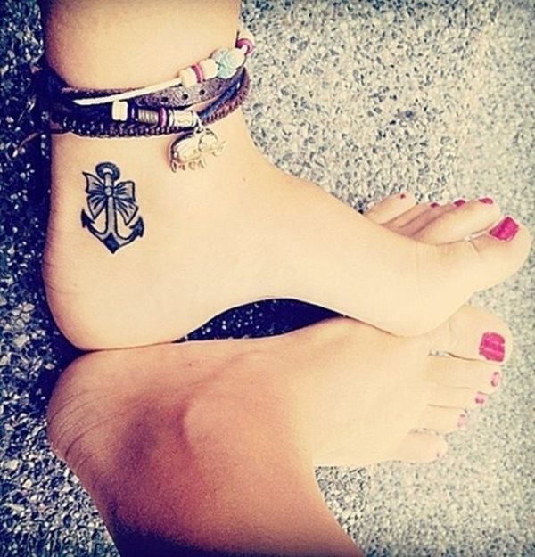Tattoo en el lateral del pie en el que podemos ver un ancla o cora pequea y con un pequeo lazo Tattoo en el lateral del pie en el que podemos ver un ancla o cora pequea y con un pequeo lazo